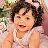baby, child, smiling, curly_hair, pink_dress, bow, portrait, happy, cute, tulle, flower_background, indoor, closeup, infant, adorable, person, headband, chubby_cheeks, toddler, celebration