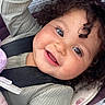 Amaya joined the competition — help win amazing prizes! toddler, child, smiling, curly_hair, car_seat, safety_harness, close_up, happy, face, cute, infant, baby, clothing, seat, seatbelt, portrait, skin, eyelashes, indoors, cozy