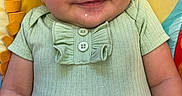 Sage joined the competition — help win amazing prizes! baby, smiling, infant, child, green_clothing, baby_seat, harness, cute, happy, portrait, colorful_background, playful, baby_boy, sitting, closeup, childcare, indoors, small_child, face, young