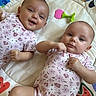 Sage joined the competition — help win amazing prizes! baby, infant, twin, playmat, onesie, smiling, lying_down, toy, colorful, cute, child, indoor, patterned_clothing, happy, face, head, soft_toy, floor, playtime, sibling