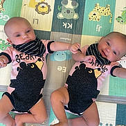 Sage joined the competition — help win amazing prizes! baby, infant, toddler, onesie, bib, playmat, animal_print, bear, giraffe, lion, cheetah, cute, smiling, lying_down, matching_clothes, child, floor, colorful, indoor, playtime