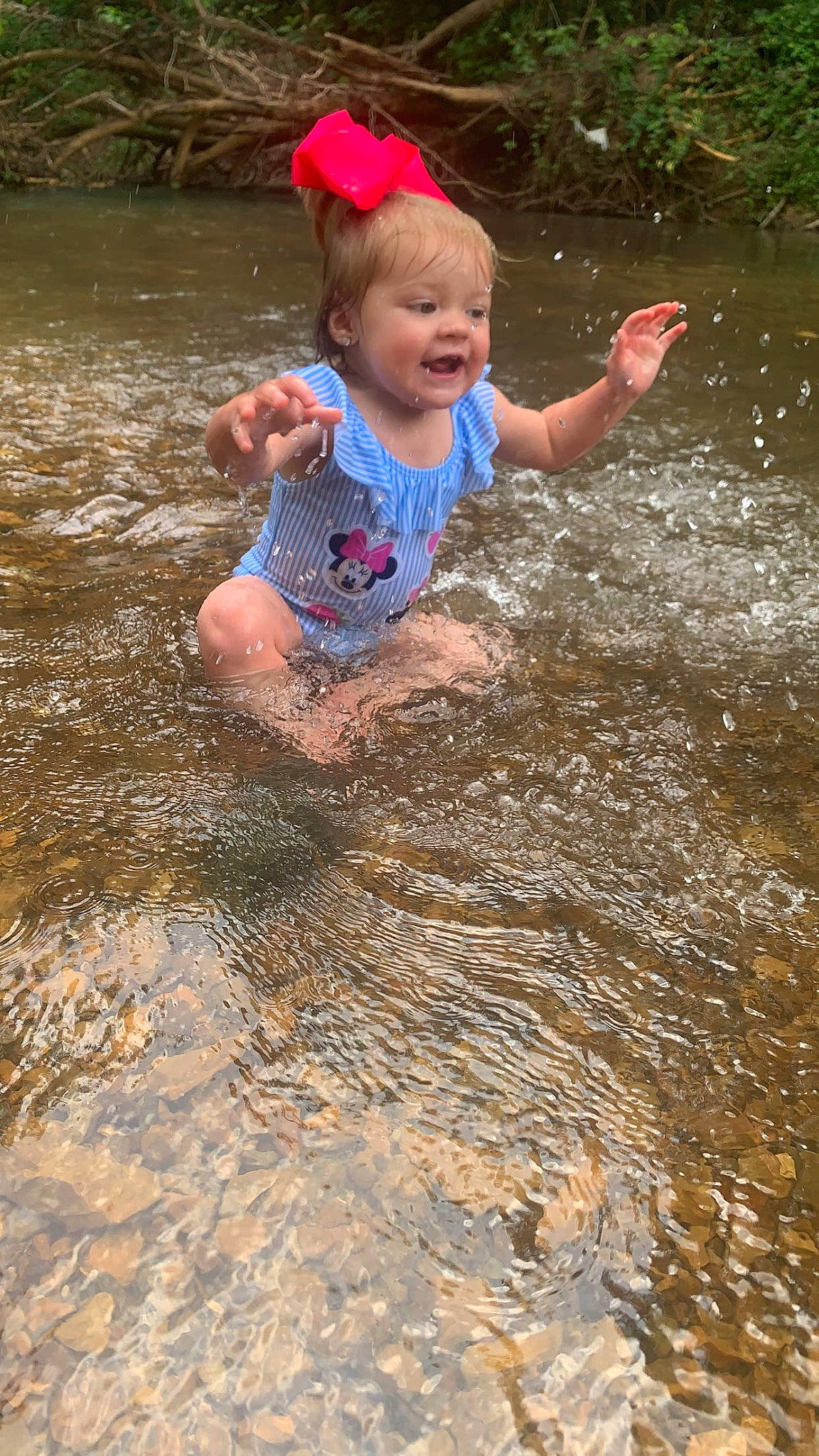 Nataleigh is registered to the contest to win money with this photo: baby, baby_toddler_clothing, child, fun, happy, head, lake, leisure, people_in_nature, person, personal_protective_equipment, plant, play, puddle, recreation, smile, soil, stream, toddler, water
