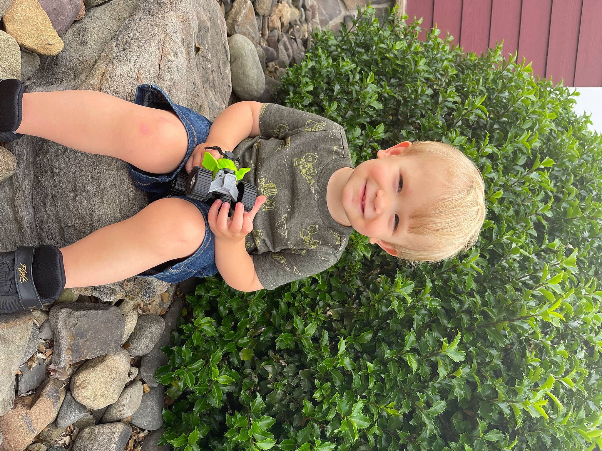 Morgan joined the competition — help win amazing prizes! baby_toddler_clothing, fun, grass, grass_family, groundcover, happy, human_leg, joy, knee, landscape, leisure, people_in_nature, person, plant, shrub, sitting, sock, soil, thigh, toddler