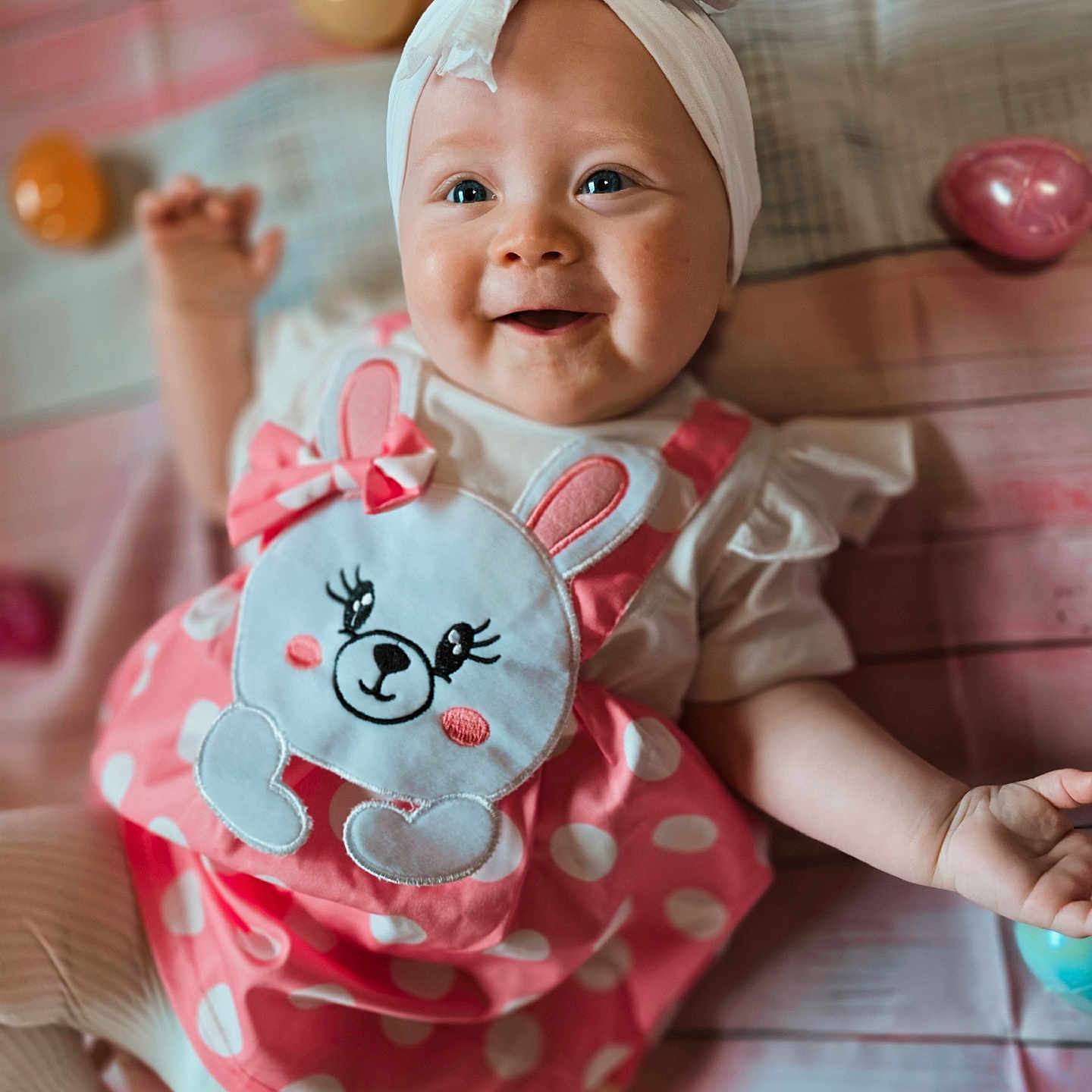 Peyton is registered to the contest to win money with this photo: accessories, applique, baby, babylaughing, bodypart, clothing, dress, face, finger, hand, happy, hat, head, pattern, people, person, photography, portrait, sitting, smile