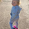 toddler, child, hoodie, rainbow, heart, leggings, sneakers, pink_shoes, outdoor, path, sunlight, portrait, walking, curious, playful, casual_clothing, young_child, fashion, daylight, cute