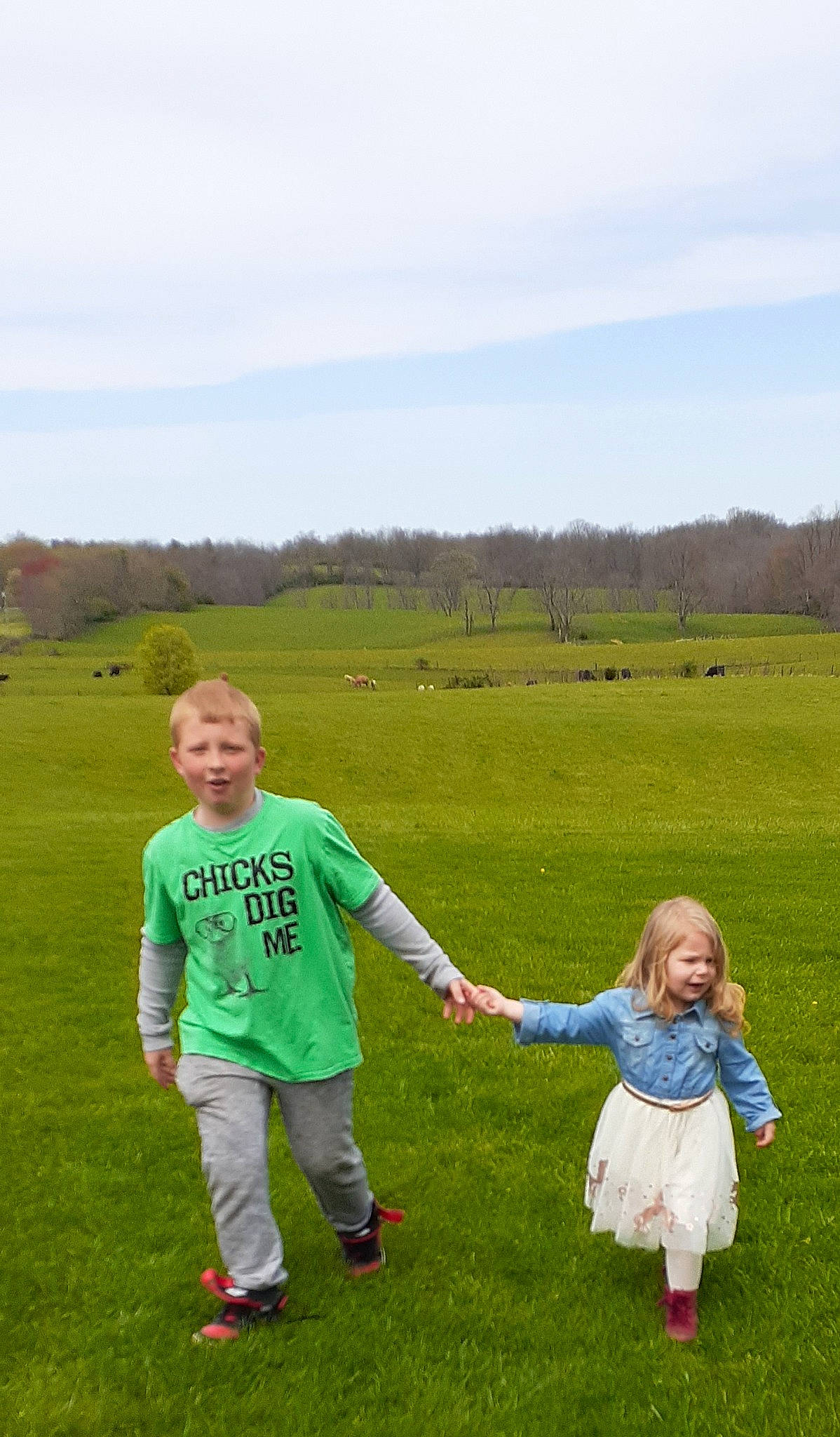 Alayna is registered to the contest to win money with this photo: cloud, fun, gesture, grass, grassland, green, happy, landscape, lawn, leisure, meadow, natural_landscape, people_in_nature, person, plain, prairie, recreation, sky, smile, toddler