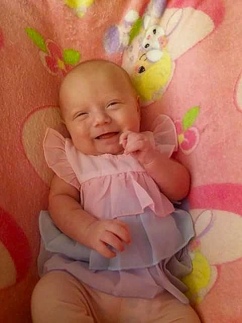 Swayze is registered to the contest to win money with this photo: baby_products, bedtime, cheek, child, ear, eye, face, finger, hair_accessory, head, infant, iris, mouth, person, petal, pink, product, skin, smile, stuffed_toy