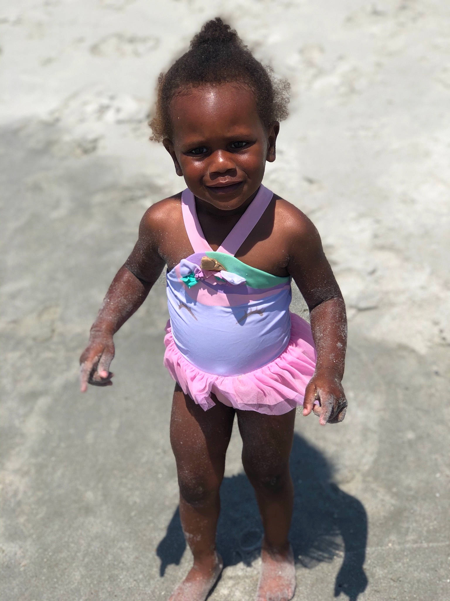 Zhavia is registered to the contest to win money with this photo: active_tank, ankle, baby_toddler_clothing, barefoot, child, facial_expression, foot, fun, joy, one_piece_swimsuit, person, pink, sand, skin, summer, swimwear, toddler, toe, undergarment, underpants