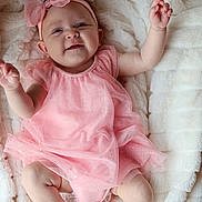 Milani joined the competition — help win amazing prizes! baby, infant, pink_dress, headband, bow, blanket, smiling, happy, cute, child, soft_texture, lying_down, skin, small_hands, small_feet, indoors, portrait, adorable, toddler, cozy