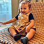 Basma is registered to the contest to win money with this photo: baby, black_shoes, casual_clothing, child, cute, dress, earrings, furniture, happy, indoor, person, pigtails, portrait, relaxed, short_hair, sitting, smiling, toddler, woven_chair, young_child