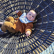 Waël participe au concours pour gagner de l'argent avec cette photo : baby, infant, child, swing, basket_swing, playground, sand, beach, rope, chain, bib, sweater, corduroy_pants, sunlight, shadow, portrait, face, outdoors, relaxing, closeup