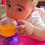 baby, child, toy, hand, face, eyes, pink, purple, orange, indoor, cute, chewing, closeup, infant, clothing, play, focus, soft, skin, young