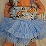 baby, pacifier, blue_outfit, headband, socks, infant, sleeping_area, soft_surface, cute, child, lying_down, sleepwear, tutu_skirt, patterned_clothing, newborn, peaceful, indoors, small_hands, side_profile, cozy