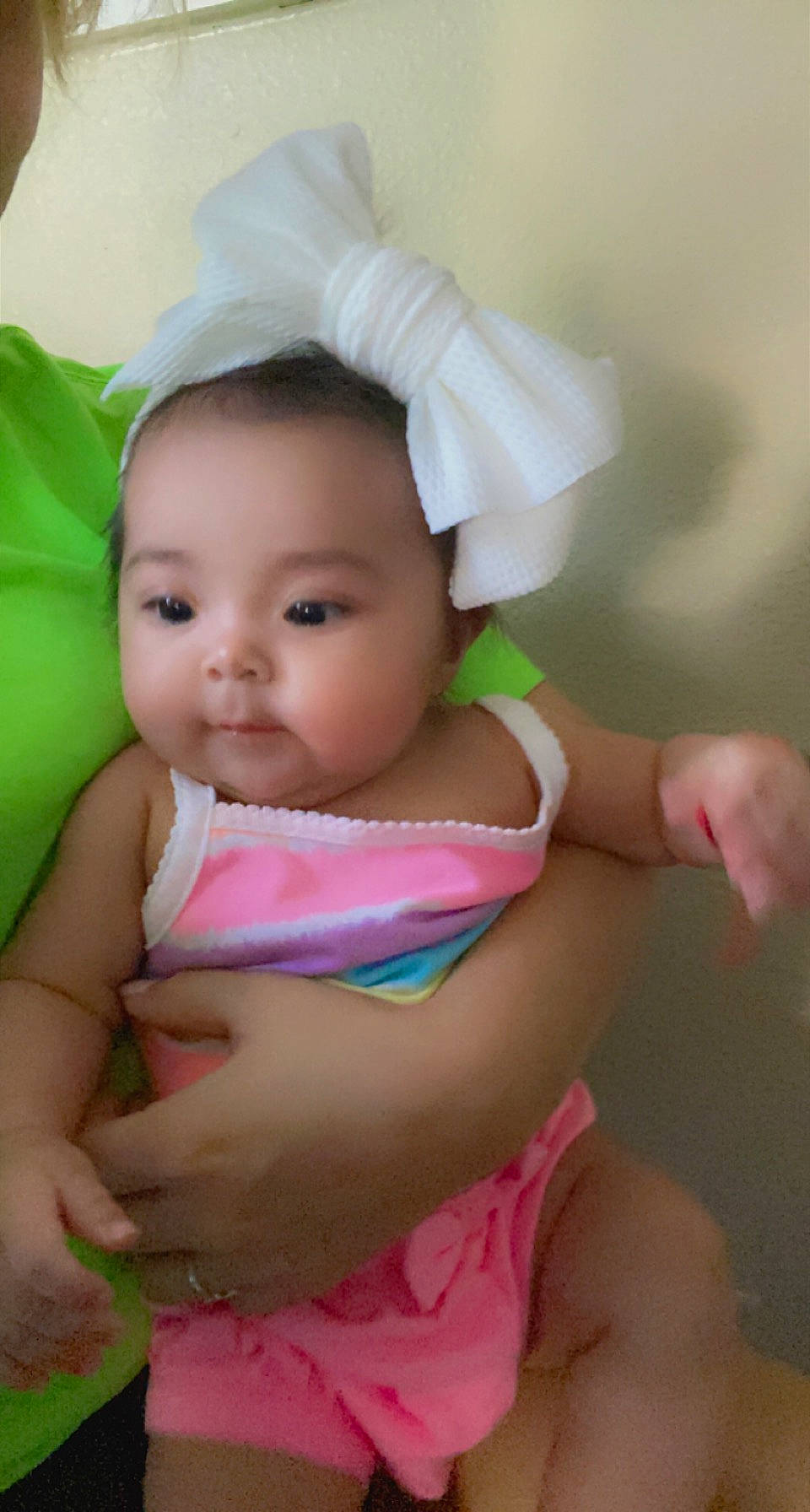 Luna is registered to the contest to win money with this photo: abdomen, arm, baby, baby_toddler_clothing, child, eyebrow, fashion_accessory, finger, fun, grass, hand, happy, human_body, lip, person, pink, sitting, skin, smile, textile