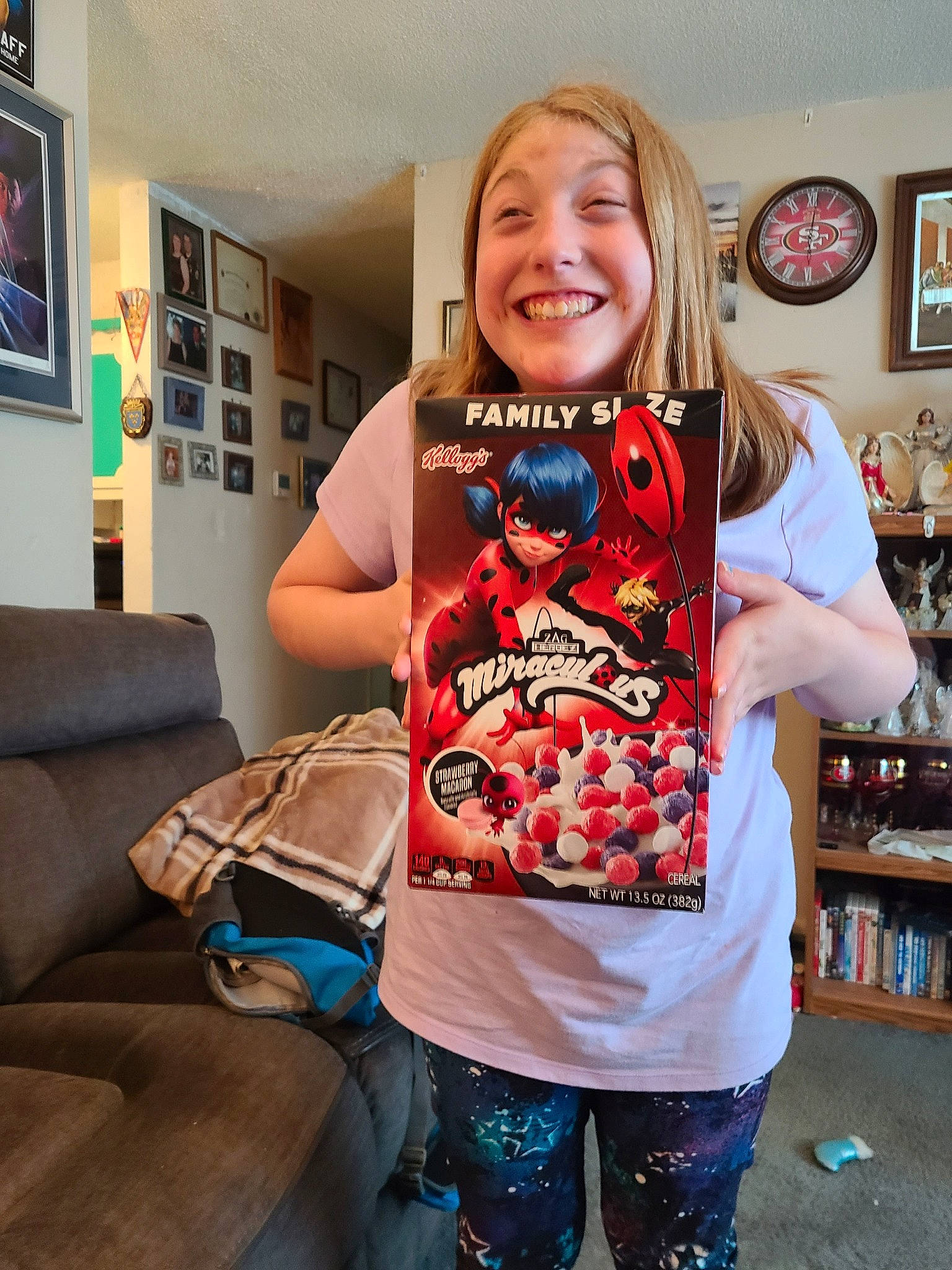 Anna joined the competition — help win amazing prizes! bag, brown_hair, child, couch, drink, event, fashion_accessory, fun, joy, luggage_and_bags, pattern, person, picture_frame, room, shelf, shopping, sleeve, smile, sportswear, t_shirt