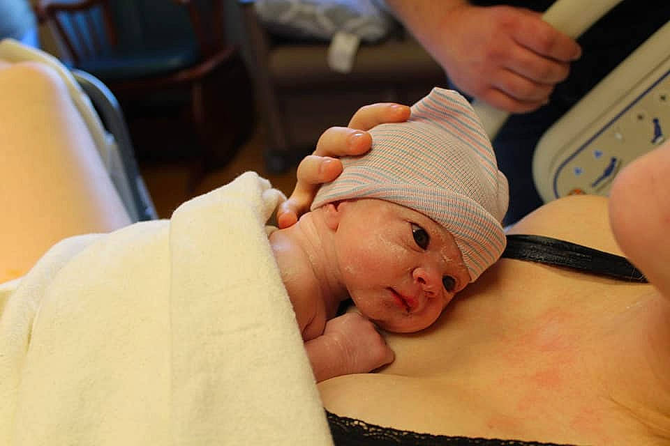 Eliza is registered to the contest to win money with this photo: baby, birth, cheek, child, childbirth, eyelash, finger, hand, headwear, mouth, person, skin