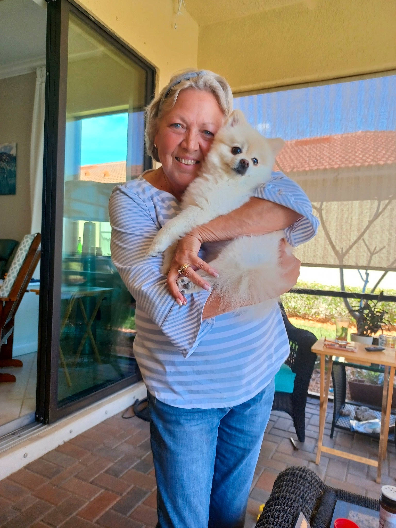 Sophie is registered to the contest to win money with this photo: child, companion_dog, dog, dog_breed, door, event, fawn, flooring, fun, happy, house, houseplant, hug, leisure, picture_frame, plant, shoulder, smile, t_shirt, vacation