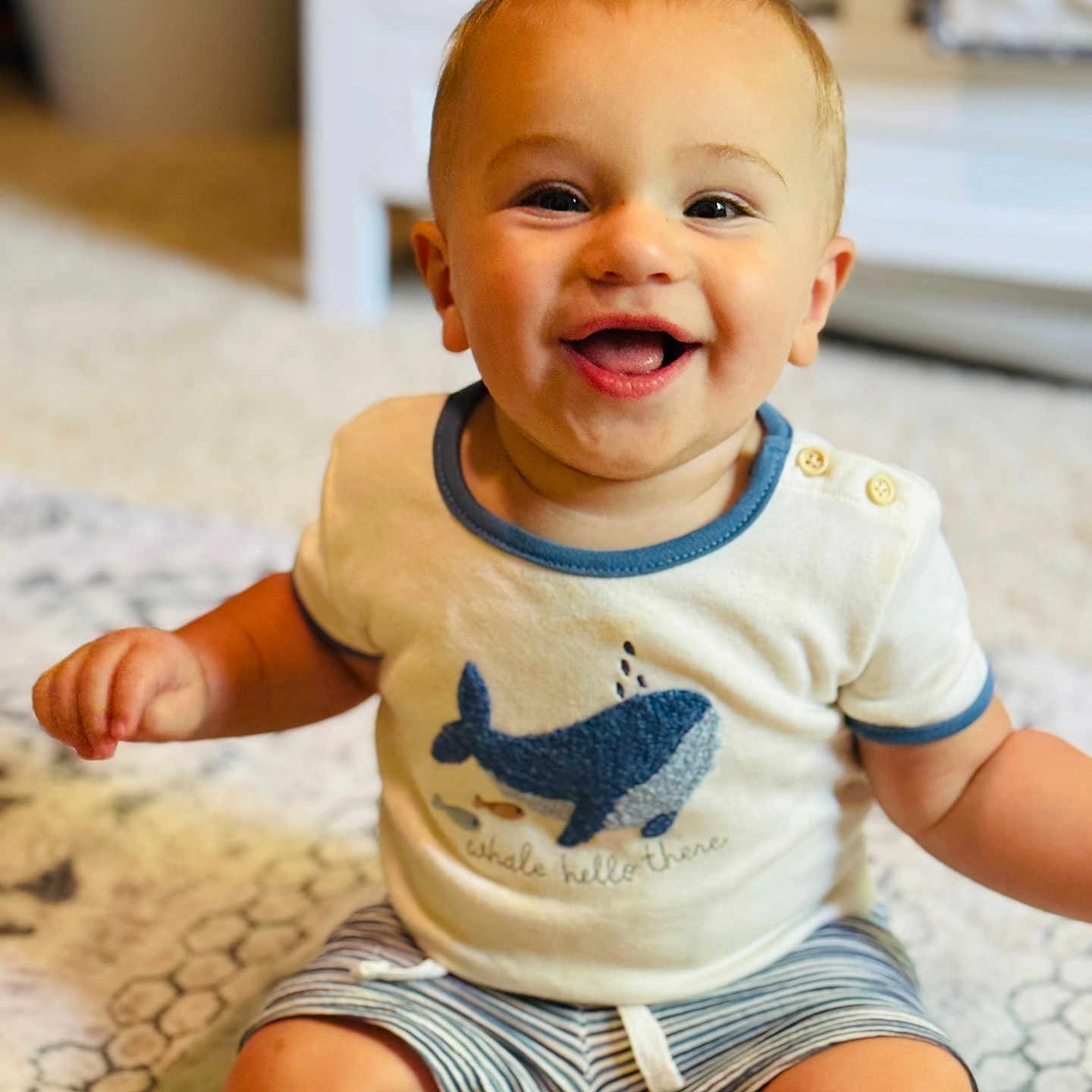Dawson is registered to the contest to win money with this photo: baby, babylaughing, bodypart, clothing, face, finger, hand, happy, head, laughing, mouth, pants, person, photography, portrait, shorts, sitting, smile, t_shirt, teeth