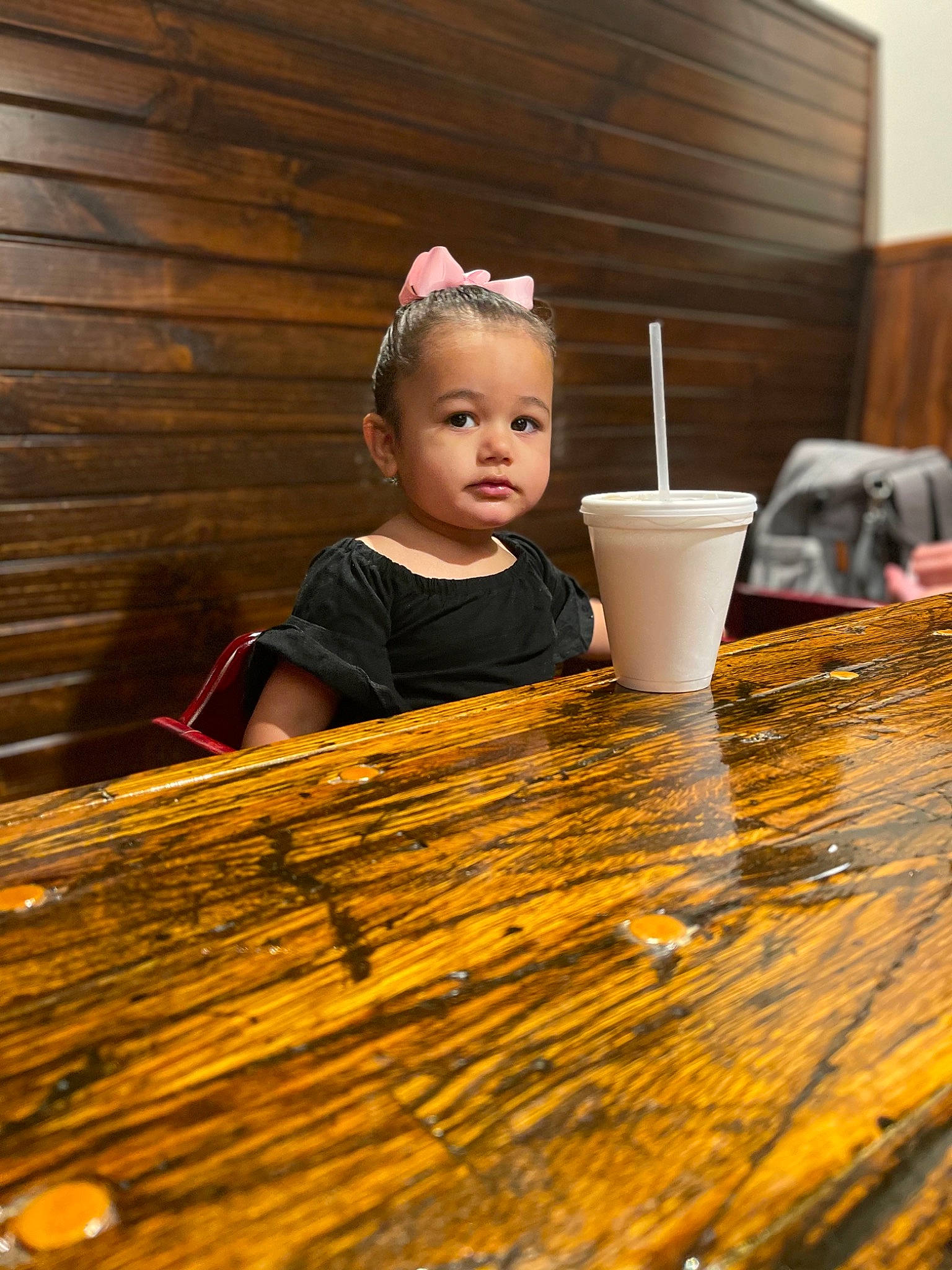 Lillyanna is registered to the contest to win money with this photo: baby_toddler_clothing, child, event, eye, flash_photography, floor, flooring, fun, grass, happy, hardwood, leisure, person, product, sitting, sunlight, table, tableware, toddler, wood