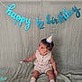 baby, child, party_hat, birthday, banner, celebration, half_birthday, sitting, cute, indoors, textile, background, decor, sock, small_object, portrait, infant, happy, one_half, milestone
