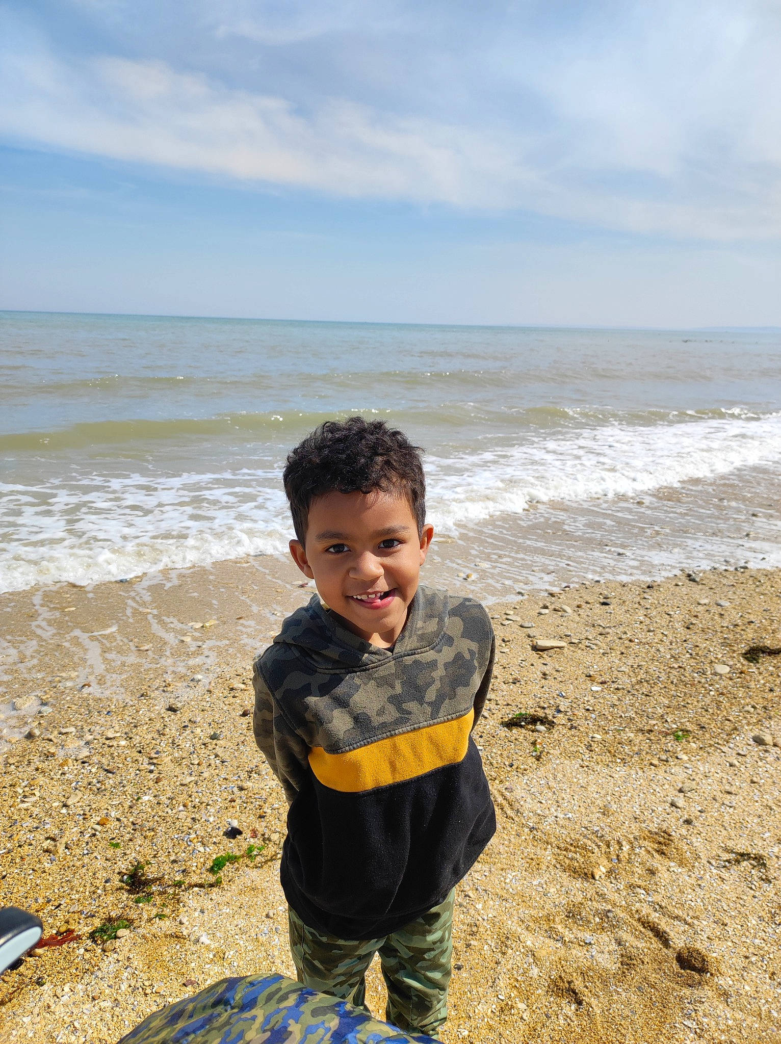Cameron participe au concours pour gagner de l'argent avec cette photo : beach, cloud, coastal_and_oceanic_landforms, fun, happy, horizon, jacket, joy, landscape, leisure, people_in_nature, person, recreation, sitting, sky, sleeve, smile, toddler, travel, water