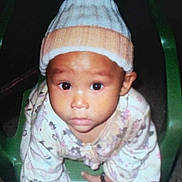 Addi is registered to the contest to win money with this photo: baby, beanie, bonnet, cap, chair, clothing, crawling, face, frown, furniture, glove, hat, head, newborn, person, photography, portrait, sad