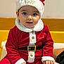Sacha a rejoint le concours — aidez-le/la à gagner de superbes lots ! baby, child, santa_claus_outfit, red_clothing, white_fur_trim, hat, holiday, christmas, festive, smiling, cute, indoor, portrait, seated, young_child, holiday_season, face, hands, costume, happy