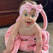 Rhett joined the competition — help win amazing prizes! baby, blue_eyes, bow, carpet, child, crawling, cute, floor, happy, headband, indoor, infant, person, pink_headband, plush_blanket, portrait, smiling, soft_texture, toddler, wooden_dresser