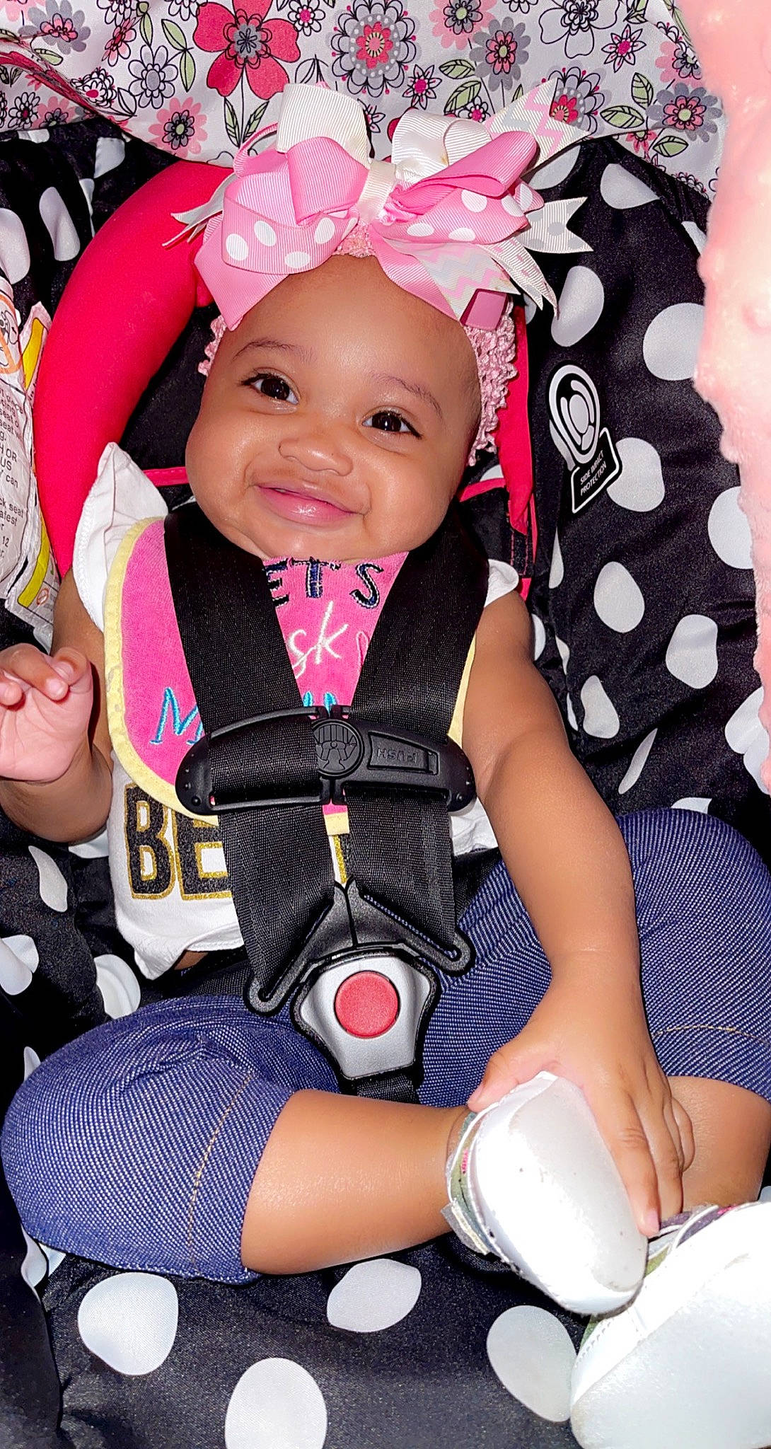 Raina is registered to the contest to win money with this photo: baby, baby_carriage, baby_products, baby_safety, baby_toddler_clothing, cheek, child, comfort, finger, happy, headwear, joy, pattern, person, pink, product, skin, sleeve, smile, textile