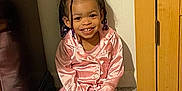 Nayeli Skye is registered to the contest to win money with this photo: child, toddler, smile, pajamas, pink_clothing, braids, marker, indoor, carpet, cabinet, wood_furniture, wall, happy, sitting, person, cute, playful, beads, young_child, home