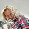 Turbo Cate Calvary is registered to the contest to win money with this photo: woman, cat, calico_cat, plaid_shirt, curly_hair, blonde_hair, indoor, ceiling_light, affection, pet, animal, human, portrait, snuggling, cozy, casual_clothing, closeup, face, holding, love
