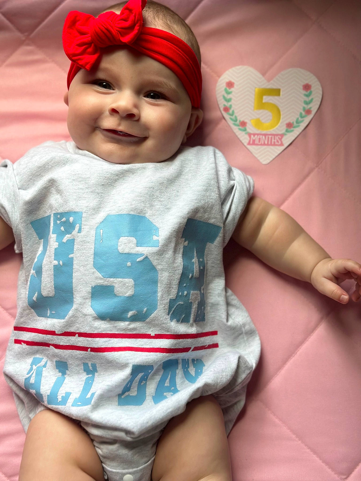 Austyn is registered to the contest to win money with this photo: baby, baby_toddler_clothing, cap, dress, eye, face, happy, head, headgear, headwear, human_body, joy, mouth, organ, outerwear, person, pink, skin, sleeve, smile