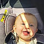 baby, blue_eyes, car_interior, car_seat, child, child_safety, closeup, clothing, cute, daylight, face, happy, infant, portrait, safety, seat, seatbelt, shadow, smiling, sunlight
