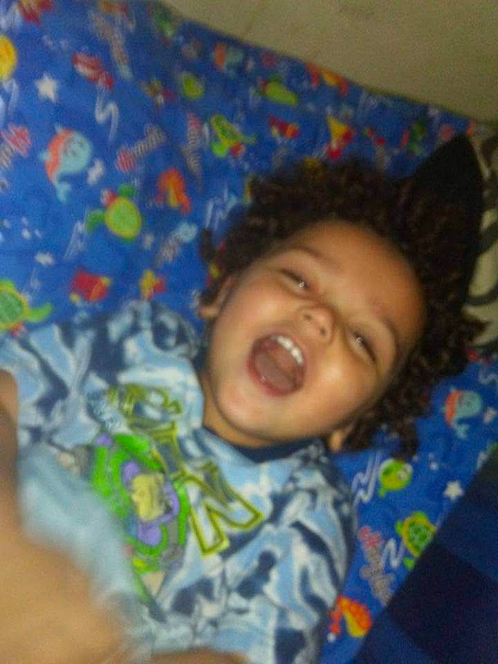 Timothy is registered to the contest to win money with this photo: bedtime, cheek, child, chin, comfort, electric_blue, eye, eyebrow, forehead, fun, happy, head, iris, linens, mouth, nose, person, skin, smile, textile