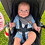 baby, stroller, child, blue_eyes, smile, outdoor, grass, plush_toy, seatbelt, bib, cute, happy, infant, person, legs, hand, clothing, sunlight, safety_strap, portrait