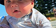 Grayson joined the competition — help win amazing prizes! baby, child, cap, hat, onesie, cartoon, lion, outdoor, sunlight, sky, trees, tattoo, watch, arm, closeup, cute, person, infant, summer, portrait
