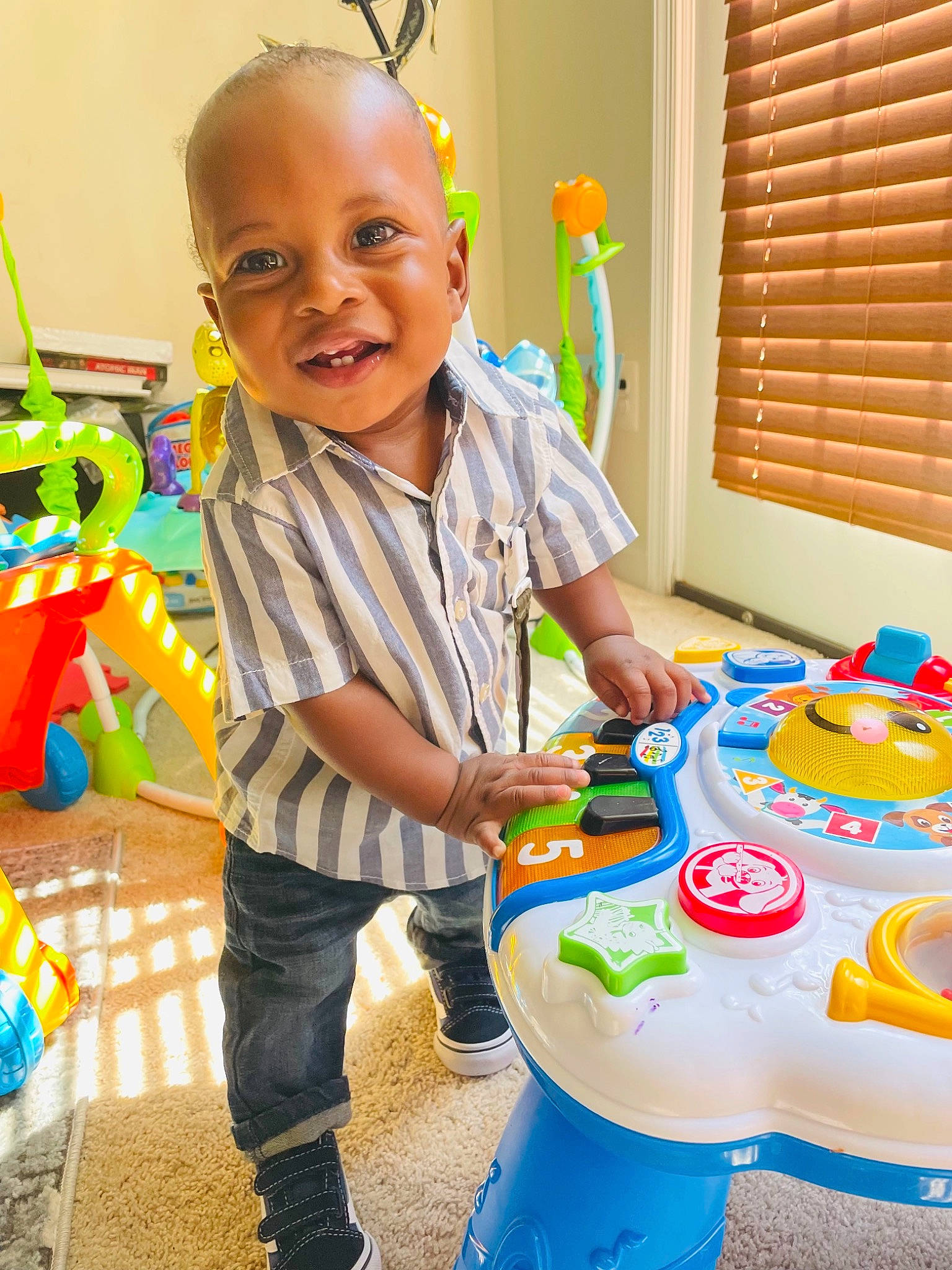 Zyon is registered to the contest to win money with this photo: baby, baby_toddler_clothing, birthday_party, blue, child, event, fun, happy, leisure, party_supply, person, play, room, shorts, smile, t_shirt, table, toddler, window, window_blind