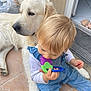 baby, dog, golden_retriever, child, teething_toy, indoor, floor, tile, pet, companion, cute, blond_hair, blue_clothing, relaxed, friendship, young_child, animal, domestic, cute_moment, home