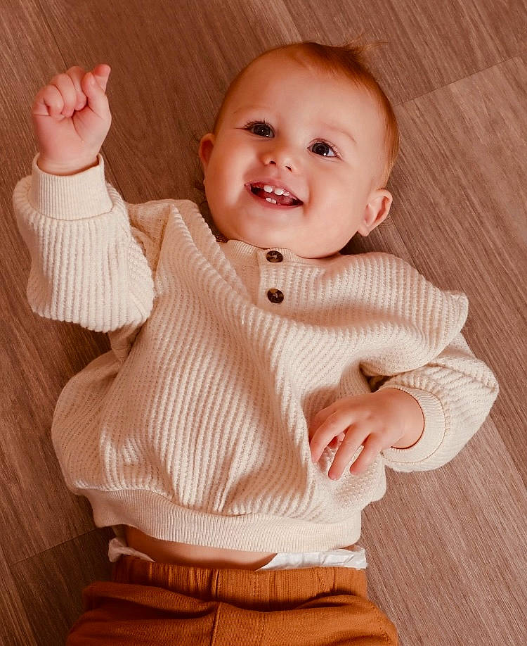 Karter is registered to the contest to win money with this photo: baby, baby_toddler_clothing, cheek, collar, comfort, face, finger, flooring, gesture, happy, head, human_body, joint, joy, person, skin, sleeve, smile, textile, thumb