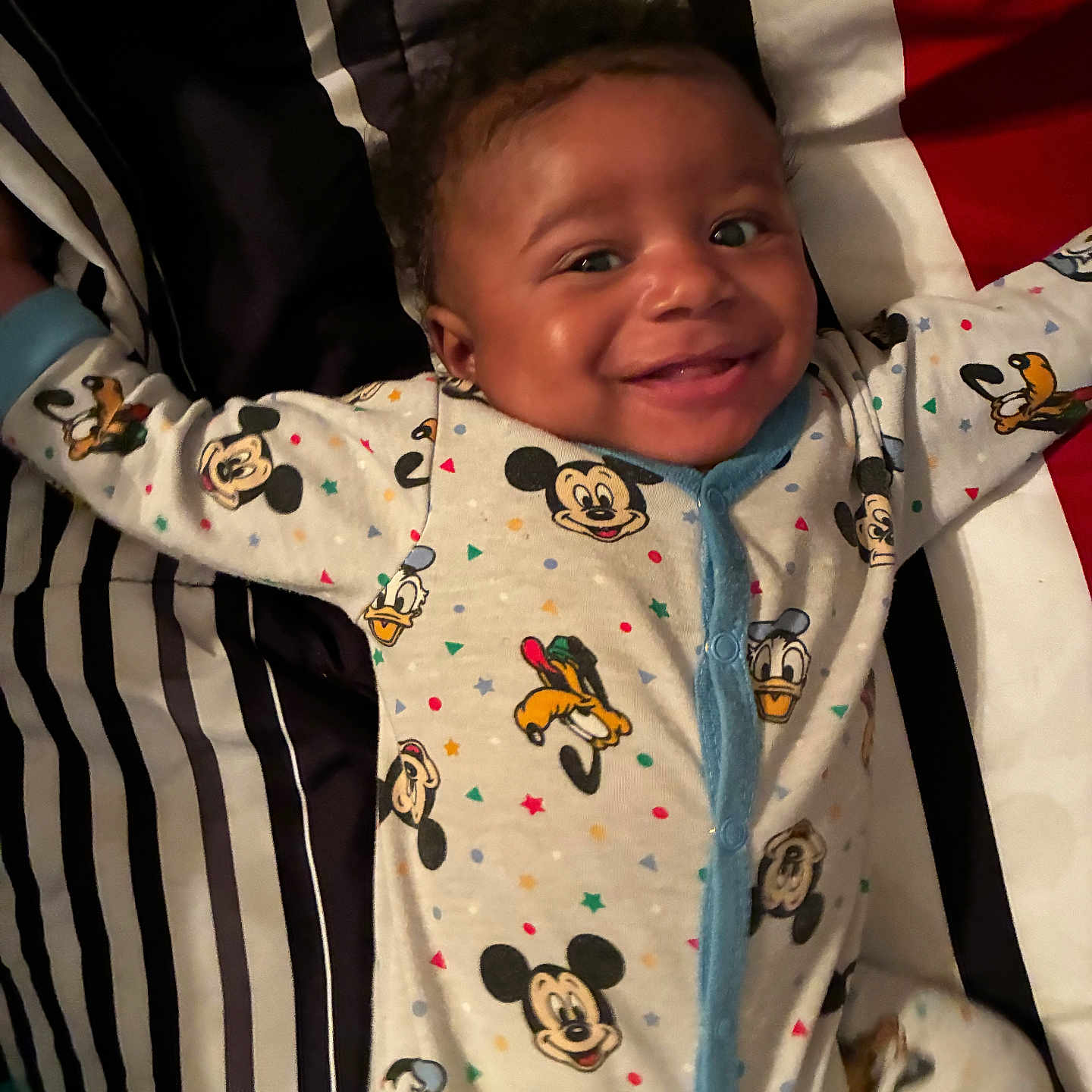 Jayden joined the competition — help win amazing prizes! baby, infant, child, smiling, happy, portrait, face, eyes, indoors, seated, onesie, pajamas, clothing, disney, mickey_mouse, donald_duck, goofy, striped_background, baby_seat, close_up