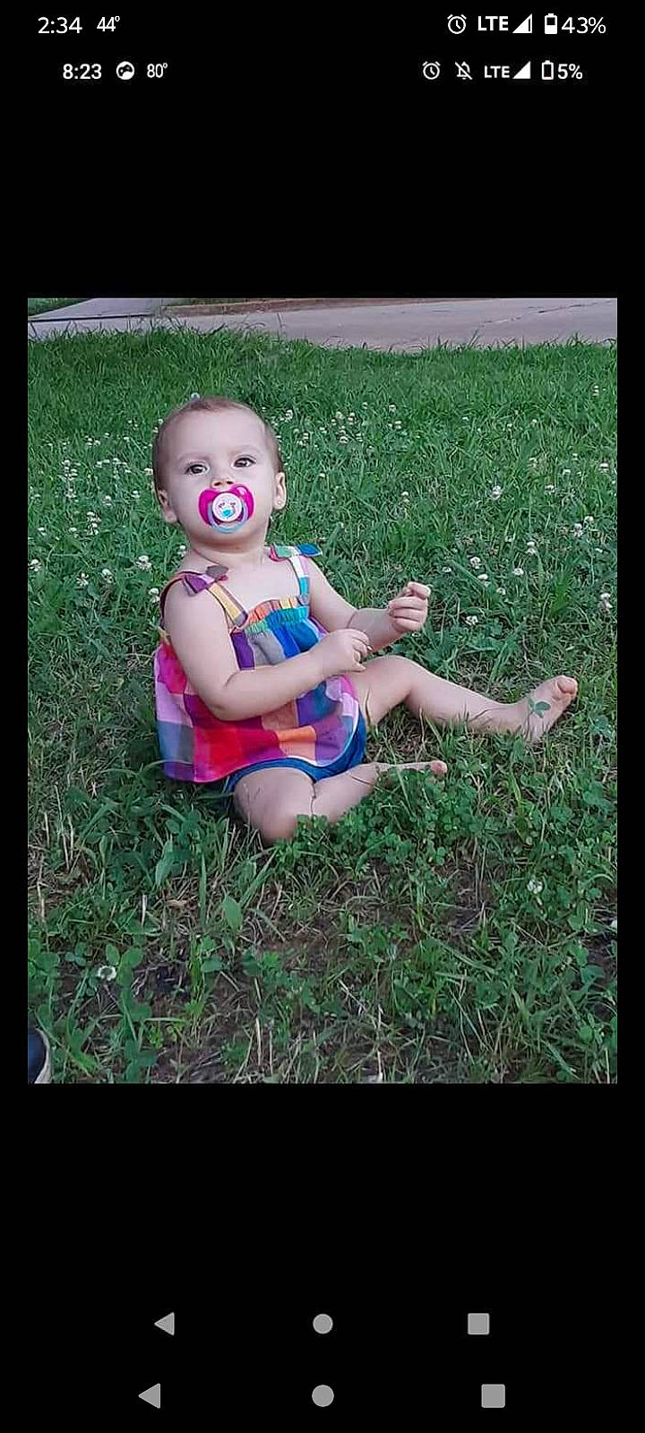 Lilah joined the competition — help win amazing prizes! baby, baby_toddler_clothing, child, finger, flash_photography, grass, grass_family, hand, happy, human_body, human_leg, lawn, leg, people_in_nature, person, plant, rectangle, sitting, smile, thumb