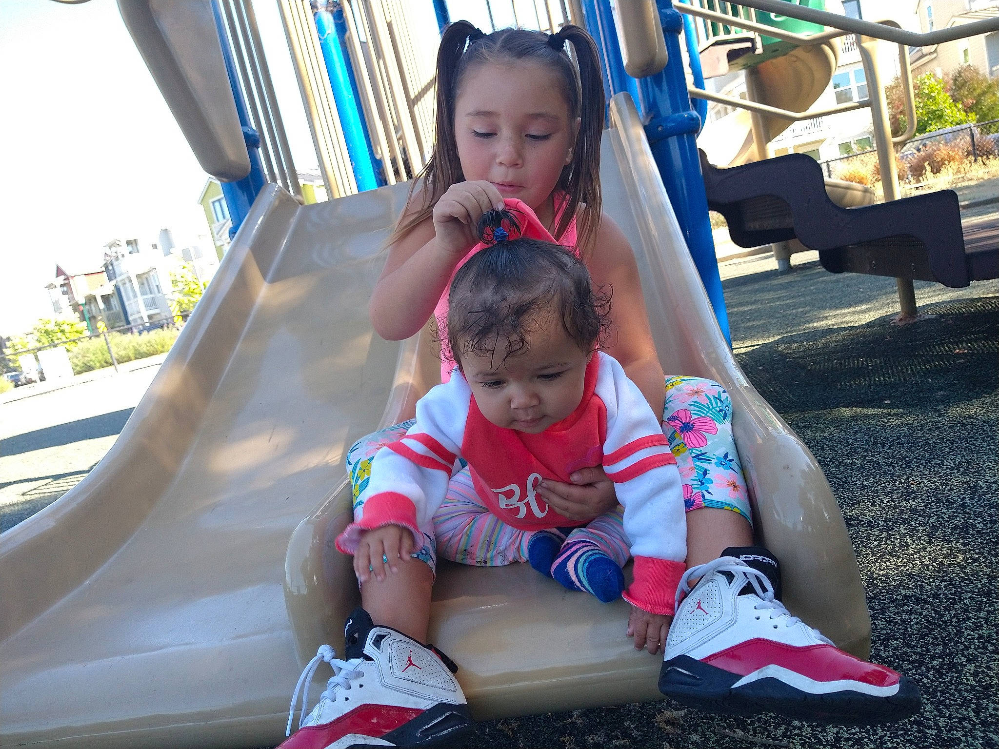 Amilliona is registered to the contest to win money with this photo: baby, child, city, fun, happy, leisure, outdoor_play_equipment, people, person, play, playground, playground_slide, public_space, recreation, sitting, skin, smile, summer, toddler, tree