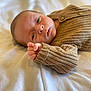 baby, beige, blanket, child, closeup, cozy, cute, expression, face, hand, indoors, infant, knit_sweater, lying_down, newborn, portrait, skin, sleeping, soft, young