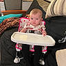 Sofia joined the competition — help win amazing prizes! baby, black_fabric, blanket, chair, child, clothing, couch, cushion, furniture, high_chair, home, indoor, living_room, person, pink, seat, serious_face, striped_pillow, table, young_child