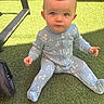 Sofia joined the competition — help win amazing prizes! baby, child, infant, onesie, blue_clothing, floral_pattern, grass, artificial_grass, outdoor, sitting, curious, wide_eyes, stroller_wheel, sunlight, shadow, cute, face, head, person, young_child