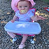 baby, child, pacifier, pink_hat, outdoor, sun_hat, high_chair, blue_eyes, clothing, footwear, rocky_ground, reaching_hand, seat, summer, cute, infant, expression, sunlight, nature, young