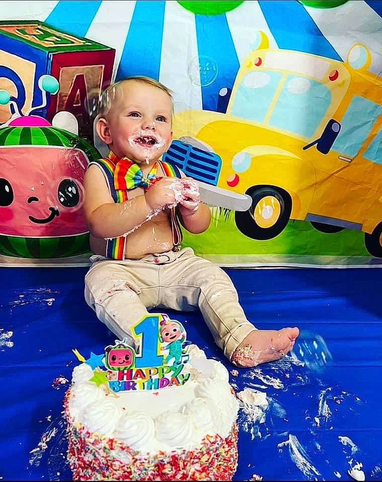Aaron is registered to the contest to win money with this photo: birthday_cake, blue, cake, cake_decorating, cake_decorating_supply, child, food, fun, green, happy, motor_vehicle, people, person, photograph, smile, snapshot, sugar_cake, tire, toddler, wheel