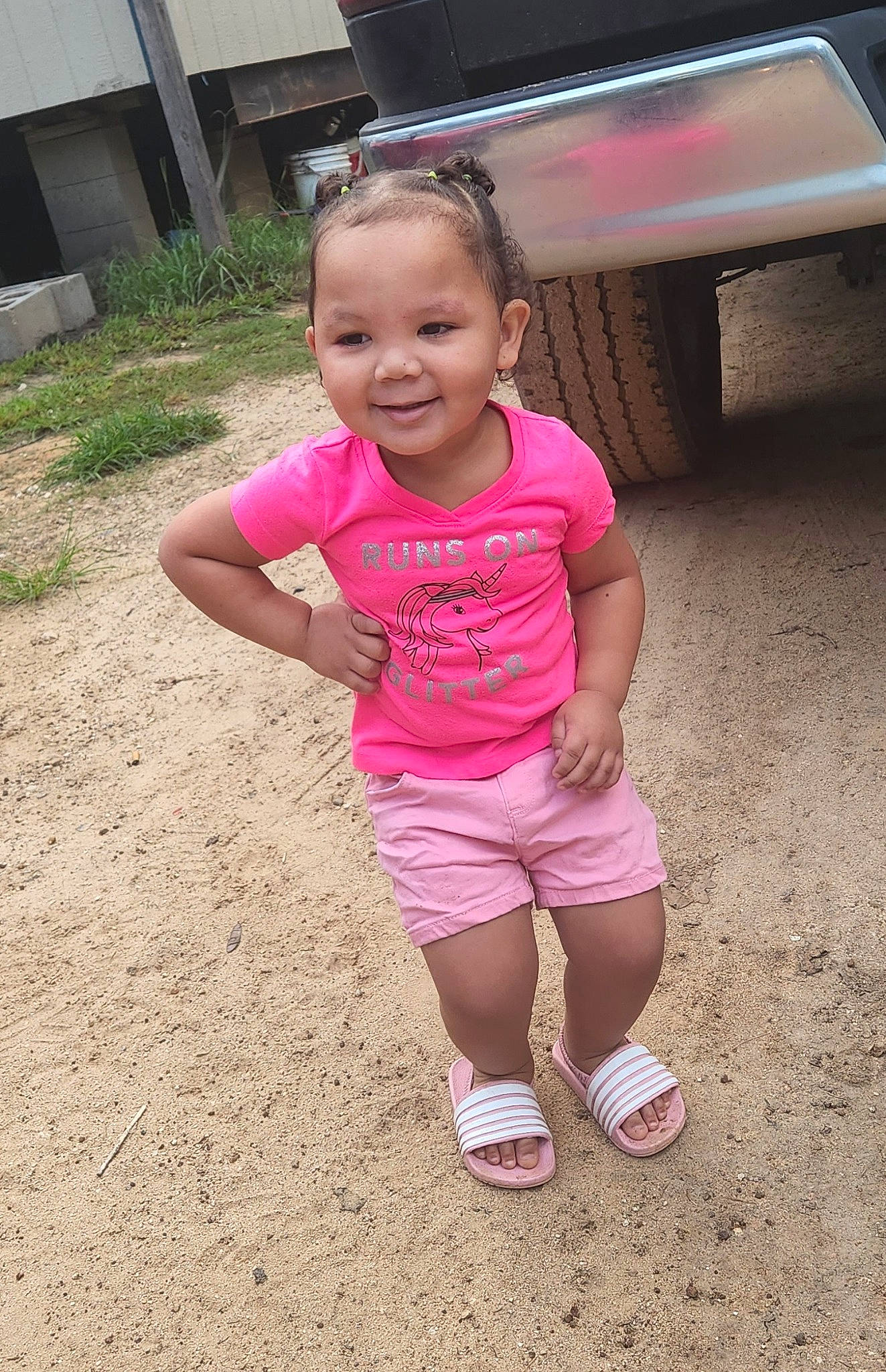 Justice is registered to the contest to win money with this photo: automotive_tire, baby_toddler_clothing, child, eye, face, fun, grass, happy, head, human_leg, joy, leisure, magenta, person, pink, recreation, smile, soil, t_shirt, thigh