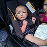 Micheal joined the competition — help win amazing prizes! baby, car_seat, child, infant, blue_eyes, sibling, glasses, smile, diaper, seatbelt, striped_shirt, car_interior, safety, cute, portrait, young_child, people, transportation, family, seat