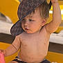 Liam participe au concours pour gagner de l'argent avec cette photo : toddler, child, hat, cap, gucci, toy, pink_toy, dirt, bare_chest, shorts, sitting, yellow_background, playful, outdoor, curious, baby, face, hand, skin, expression